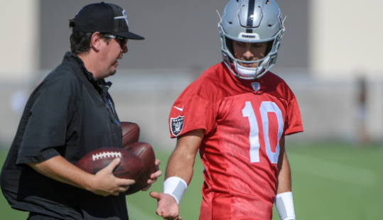 Las Vegas Raiders quarterback Jimmy Garoppolo (10) wipes away